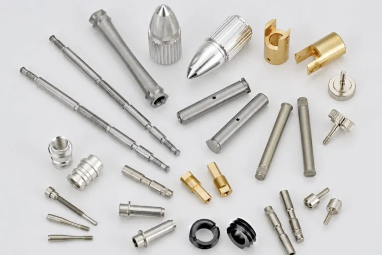 Custom CNC fasteners including stepped shafts, dowel pins, knurled thumb screws, collars, and brass bushings in stainless steel, aluminum, and brass
